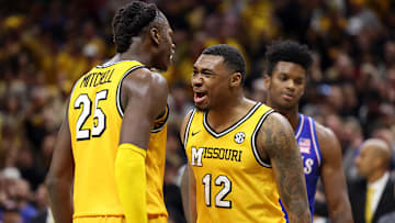 Missouri Tigers Mark Mitchell (25), and Tony Perkins (12), celebrate as they finish a huge win versus rival Kansas Jayhawks.