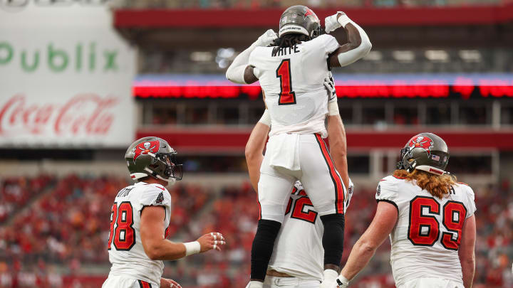 Aug 23, 2024; Tampa, Florida, USA; Tampa Bay Buccaneers running back Rachaad White (1) center Graham Barton (62) after scoring a touchdown against the Miami Dolphins in the first quarter during preseason at Raymond James Stadium. Mandatory Credit: Nathan Ray Seebeck-USA TODAY Sports