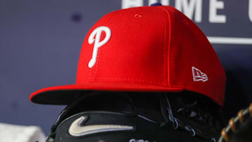 May 26, 2023; Atlanta, Georgia, USA; A detailed view of a Philadelphia Phillies hat and glove on the bench against the Atlanta Braves in the seventh inning at Truist Park. 