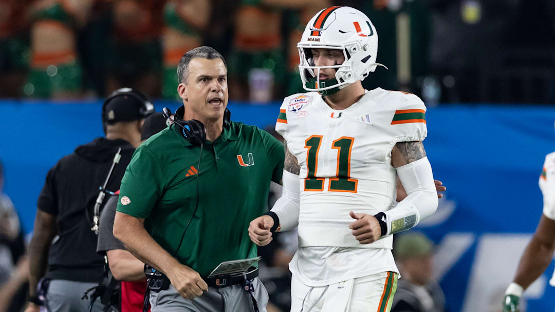 Carson Beck #11 confers with Mario Cristobal of the Miami (FL) Hurricanes in the second quarter of the 2025 College Football Playoff Semifinal at State Farm Stadium on January 8, 2026 in Glendale, Arizona. Carson Beck #11 confers with Mario Cristobal of the Miami (FL) Hurricanes in the second quarter of the 2025 College Football Playoff Semifinal at State Farm Stadium on January 8, 2026 in Glendale, Arizona.
