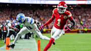 Kansas City Chiefs wide receiver Xavier Worthy (1) makes a catch for a touchdown against Detroit Lions cornerback Amik Robertson (21) during the first half at Arrowhead Stadium in Kansas City, Missouri on Sunday, Oct. 12, 2025.