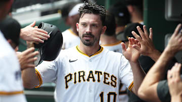 Jun 29, 2025; Pittsburgh, Pennsylvania, USA;  Pittsburgh Pirates right fielder Bryan Reynolds (10) high-fives in the dugout after scoring a run against the New York Mets during first inning at PNC Park. 