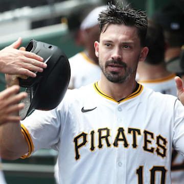 Jun 29, 2025; Pittsburgh, Pennsylvania, USA;  Pittsburgh Pirates right fielder Bryan Reynolds (10) high-fives in the dugout after scoring a run against the New York Mets during first inning at PNC Park. 