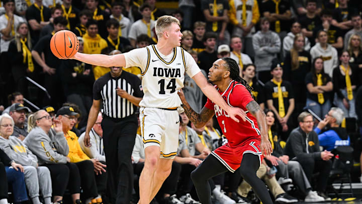 Nov 4, 2025; Iowa City, Iowa, USA; Iowa Hawkeyes guard Bennett Stirtz (14) controls the ball as Robert Morris Colonials guard Ta'Zir Smith (3) defends during the first half at Carver-Hawkeye Arena. Mandatory Credit: Jeffrey Becker-Imagn Images
