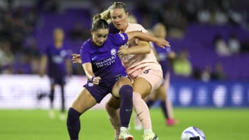 Mar 22, 2024; Orlando, Florida, USA;  Orlando Pride midfielder Ally Lemos (30) and Angel City FC midfielder Amandine Henry (26) battle for the ball in the second half at Inter&Co Stadium. Mandatory Credit: Nathan Ray Seebeck-USA TODAY Sports