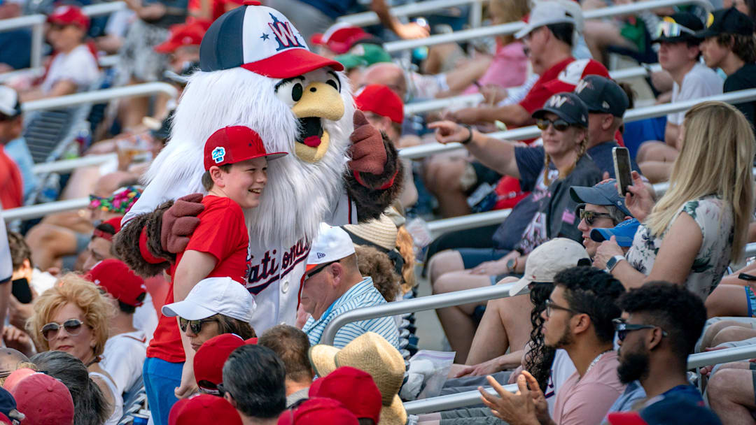 Fans pose for photos at Washington Nationals and St. Louis Cardinals spring training game at the Ballpark of the Palm Beaches in West Palm Beach, Florida on March 4, 2023.