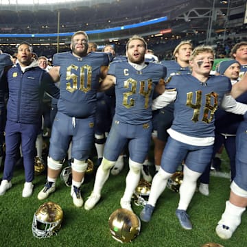 Nov 23, 2024; New York, New York, USA; Notre Dame Fighting Irish head coach Marcus Freeman and his players sing the Notre Dame alma mater after a win against the Army Black Knights at Yankee Stadium. Mandatory Credit: Danny Wild-Imagn Images