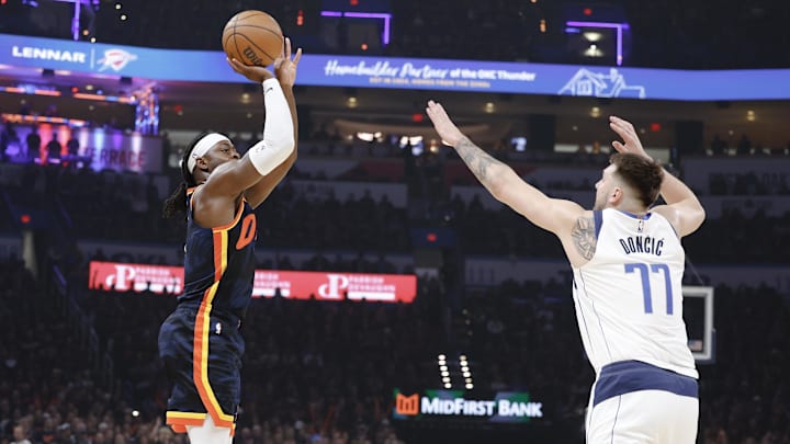 May 15, 2024; Oklahoma City, Oklahoma, USA;Oklahoma City Thunder guard Luguentz Dort (5) shoots a three-point basket as Dallas Mavericks guard Luka Doncic (77) defends during the first quarter of game five of the second round for the 2024 NBA playoffs at Paycom Center. Mandatory Credit: Alonzo Adams-Imagn Images