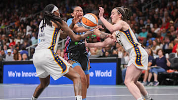May 22, 2025; Atlanta, Georgia, USA; Atlanta Dream guard Te-Hina Paopao (2) is defended by Indiana Fever forward Natasha Howard (6) and guard Caitlin Clark (22) in the first half at State Farm Arena. Mandatory Credit: Brett Davis-Imagn Images