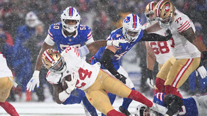 Dec 1, 2024; Orchard Park, New York, USA; San Francisco 49ers running back Jordan Mason (24) is tackled by Buffalo Bills linebacker Nicholas Morrow (32) in the second quarter at Highmark Stadium. Mandatory Credit: Mark Konezny-Imagn Images