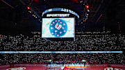 Dec 3, 2024; Calgary, Alberta, CAN; Johnny Gaudreau’s family on the ice during ceremonial puck drop by Columbus Blue Jackets center Sean Monahan (23) and Calgary Flames center Mikael Backlund (11) prior to the game between the Calgary Flames and the Columbus Blue Jackets at Scotiabank Saddledome. Mandatory Credit: Sergei Belski-Imagn Images