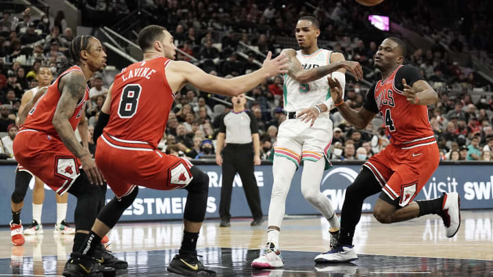 San Antonio Spurs guard Dejounte Murray (5) passes the ball while defended by Chicago Bulls guards DeMar DeRozan (11), Zach LaVine (8) and Javonte Green (24) during the second half at ATT Center. Mandatory Credit: