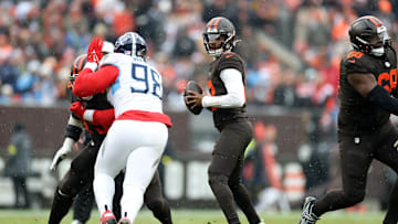 Dec 7, 2025; Cleveland, Ohio, USA; Cleveland Browns quarterback Shedeur Sanders (12) looks to throw a pass against Tennessee Titans defensive tackle Jeffery Simmons (98) during the first quarter at Huntington Bank Field. Mandatory Credit: Scott Galvin-Imagn Images