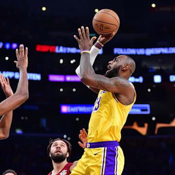 Dec 31, 2024; Los Angeles, California, USA; Los Angeles Lakers forward LeBron James (23) shoots against Cleveland Cavaliers forward Evan Mobley (4) during the first half at Crypto.com Arena. Mandatory Credit: Gary A. Vasquez-Imagn Images