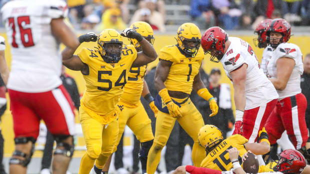 West Virginia Mountaineers defensive lineman Fatorma Mulbah (54) celebrates. Ben Queen-USA TODAY Sports