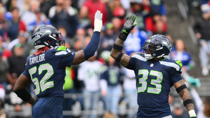 Oct 22, 2023; Seattle, Washington, USA; Seattle Seahawks linebacker Darrell Taylor (52) and safety Jamal Adams (33) celebrate after the defense made a play against the Arizona Cardinals during the first half at Lumen Field. Mandatory Credit: Steven Bisig-USA TODAY Sports