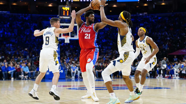 Apr 9, 2022; Philadelphia, Pennsylvania, USA; Philadelphia 76ers center Joel Embiid (21) looks to make a move against Indiana Pacers point guard T.J. McConnell (9) and Indiana Pacers forward Isaiah Jackson (23) during the second half at Wells Fargo Center. Mandatory Credit: Gregory Fisher-USA TODAY Sports