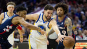 Feb 7, 2024; Philadelphia, Pennsylvania, USA; Golden State Warriors guard Klay Thompson (11) reaches for a loose ball between Philadelphia 76ers forward KJ Martin (1) and guard Kelly Oubre Jr. (9) during the third quarter at Wells Fargo Center. Mandatory Credit: Bill Streicher-USA TODAY Sports