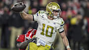Nov 29, 2024; Athens, Georgia, USA; Georgia Tech Yellow Jackets quarterback Haynes King (10) tries to escape the rush of Georgia Bulldogs linebacker CJ Allen (3) during overtime at Sanford Stadium. Mandatory Credit: Dale Zanine-Imagn Images