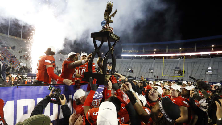 Dec 16, 2023; Shreveport, LA, USA; Texas Tech Red Raiders quarterback Behren Morton (2), running back Tahj Brooks (28) and linebacker Jacob Rodriguez (10) share the  Independence Bowl trophy with teammates after defeating the California Golden Bears at Independence Stadium. Mandatory Credit: Petre Thomas-USA TODAY Sports