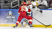 Apr 10, 2025; St. Louis, Missouri, UNITED STATES; Western Michigan Broncos forward Tim Washe (16) and Denver Pioneers defenseman Eric Pohlkamp (23) battle for the puck during the second period of the Frozen Four college ice hockey national semifinals at Enterprise Center. Mandatory Credit: Jeff Curry-Imagn Images