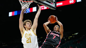 Nov 27, 2024; Las Vegas, Nevada, USA; Houston Cougars guard Milos Uzan (7) shoots against Notre Dame Fighting Irish forward Burke Chebuhar (21) during the second half at MGM Grand Garden Arena. Mandatory Credit: Stephen R. Sylvanie-Imagn Images