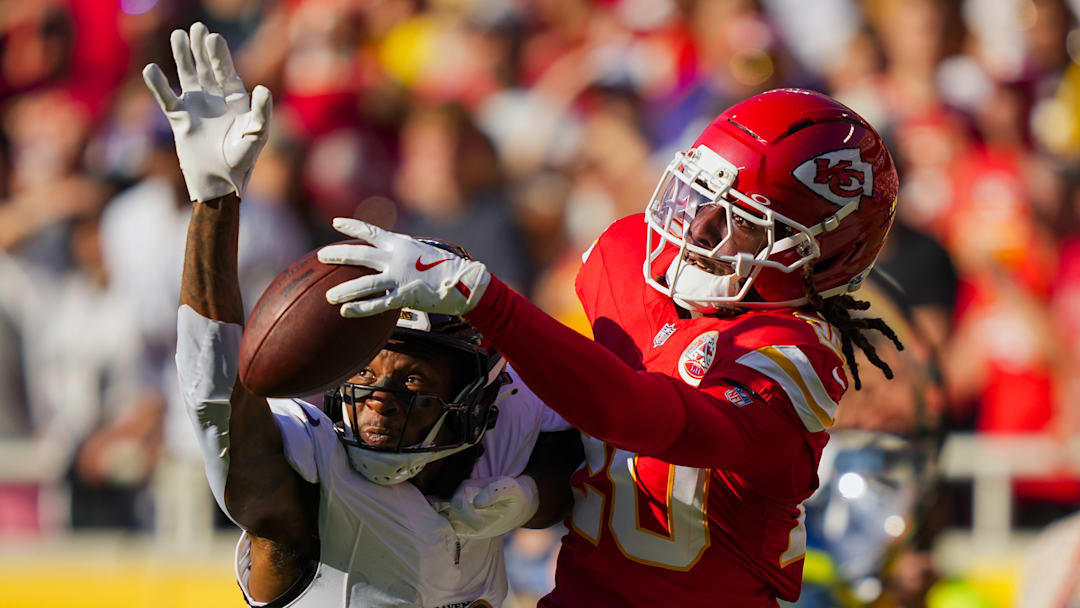 Sep 28, 2025; Kansas City, Missouri, USA; Kansas City Chiefs cornerback Nohl Williams (20) breaks up a pass intended for Baltimore Ravens wide receiver Deandre Hopkins (10) during the first half at GEHA Field at Arrowhead Stadium. Mandatory Credit: Jay Biggerstaff-Imagn Images