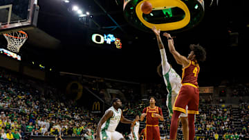 USC guard Chad Baker-Mazara right, takes a shot over Oregon forward Devon Pryor as the Oregon Ducks host the USC Trojans at Matthew Knight Arena in Eugene, Oregon on Dec. 2, 2025.