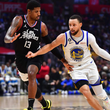 Mar 15, 2023; Los Angeles, California, USA; Golden State Warriors guard Stephen Curry (30) moves the ball against Los Angeles Clippers forward Paul George (13) during the first half at Crypto.com Arena. Mandatory Credit: Gary A. Vasquez-USA TODAY Sports