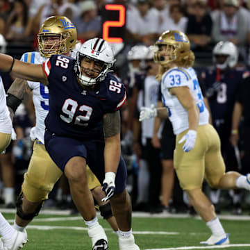 Nov 4, 2023; Tucson, Arizona, USA; Arizona Wildcats defensive lineman Tyler Manoa #92 hits UCLA Bruins quarterback Ethan Garbers #4 as the pass comes back to him during the second half at Arizona Stadium. Mandatory Credit: Zachary BonDurant-Imagn Images