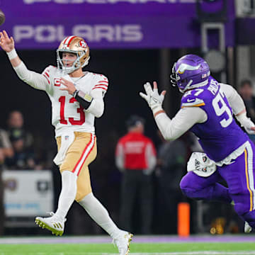 Oct 23, 2023; Minneapolis, Minnesota, USA; San Francisco 49ers quarterback Brock Purdy (13) passes against the Minnesota Vikings defensive tackle Harrison Phillips (97) in the fourth quarter at U.S. Bank Stadium. Mandatory Credit: Brad Rempel-Imagn Images