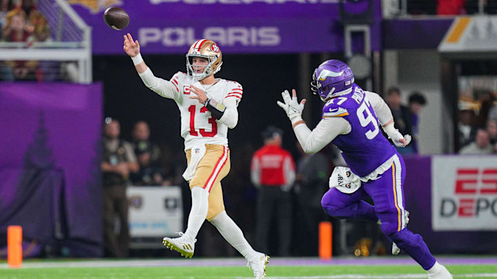 Oct 23, 2023; Minneapolis, Minnesota, USA; San Francisco 49ers quarterback Brock Purdy (13) passes against the Minnesota Vikings defensive tackle Harrison Phillips (97) in the fourth quarter at U.S. Bank Stadium. Mandatory Credit: Brad Rempel-Imagn Images