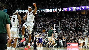Mar 6, 2024; East Lansing, Michigan, USA; Michigan State Spartans guard Tyson Walker (2) celebrates with guard Tre Holloman (5) as they defeat the Northwestern Wildcats at Jack Breslin Student Events Center. Mandatory Credit: Dale Young-Imagn Images