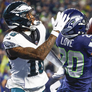 Dec 18, 2023; Seattle, Washington, USA; Seattle Seahawks safety Julian Love (20) intercepts a pass intended for Philadelphia Eagles wide receiver Quez Watkins (16) during the fourth quarter at Lumen Field. Mandatory Credit: Joe Nicholson-USA TODAY Sports