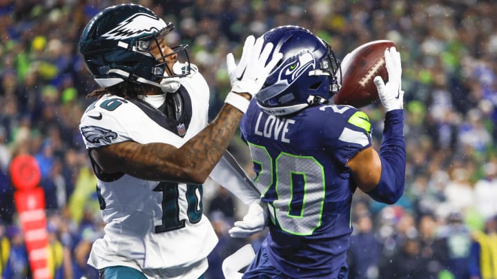 Dec 18, 2023; Seattle, Washington, USA; Seattle Seahawks safety Julian Love (20) intercepts a pass intended for Philadelphia Eagles wide receiver Quez Watkins (16) during the fourth quarter at Lumen Field. Mandatory Credit: Joe Nicholson-USA TODAY Sports