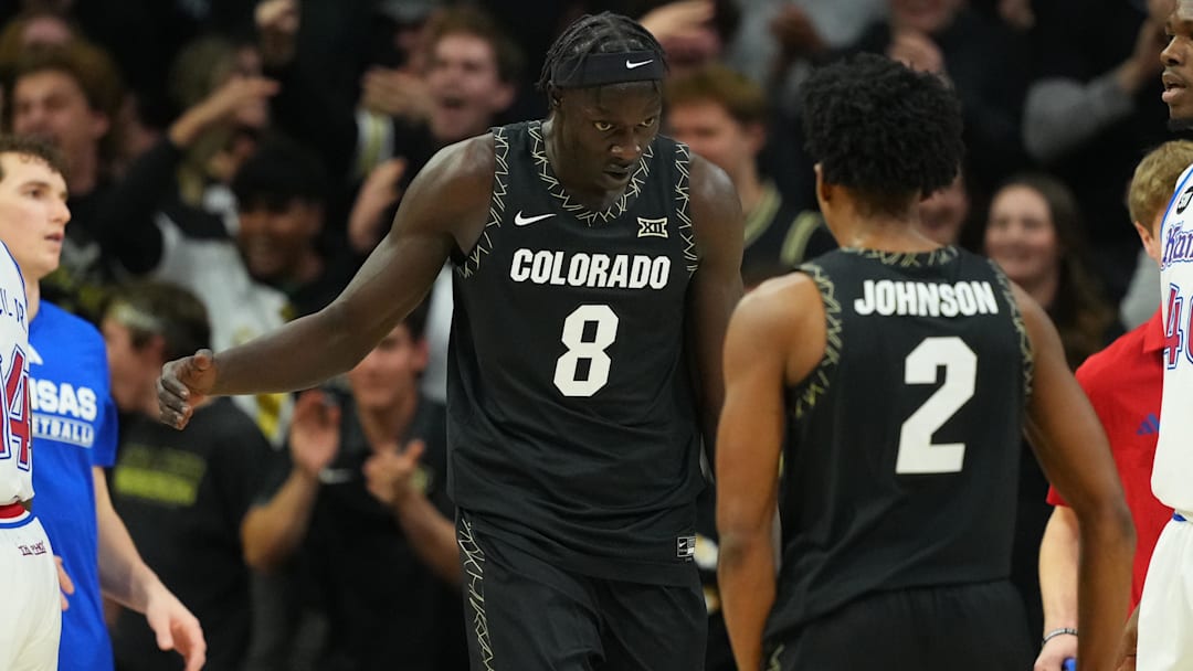Jan 20, 2026; Boulder, Colorado, USA; Colorado Buffaloes forward Bangot Dak (8) reacts after a score with guard Isaiah Johnson (2) in the first half against the Kansas Jayhawks at the CU Events Center. Mandatory Credit: Ron Chenoy-Imagn Images