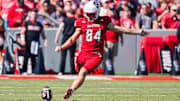 Oct 4, 2025; Raleigh, North Carolina, USA;  NC State Wolfpack kicker Charlie Birtwistle (84) kicks the ball during the first half of the game against Campbell Fighting Camels at Carter-Finley Stadium. Mandatory Credit: Jaylynn Nash-Imagn Images
