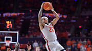 Dec 10, 2024; Champaign, Illinois, USA;  Illinois Fighting Illini guard Tre White (22) leaps for a pass during the second half against the Wisconsin Badgers at State Farm Center. Mandatory Credit: Ron Johnson-Imagn Images