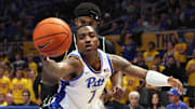 Nov 10, 2025; Pittsburgh, Pennsylvania, USA;  Pittsburgh Panthers guard Damarco Minor (7) reaches for a rebound ahead of Eastern Michigan Eagles guard Jon Sanders II (10) during the second half at Petersen Events Center. Mandatory Credit: Charles LeClaire-Imagn Images