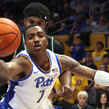 Nov 10, 2025; Pittsburgh, Pennsylvania, USA;  Pittsburgh Panthers guard Damarco Minor (7) reaches for a rebound ahead of Eastern Michigan Eagles guard Jon Sanders II (10) during the second half at Petersen Events Center. Mandatory Credit: Charles LeClaire-Imagn Images