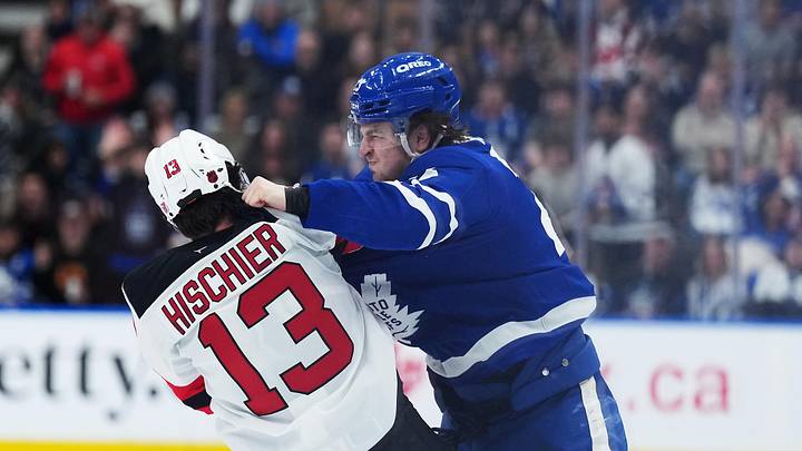Dec 30, 2025; Toronto, Ontario, CAN; Toronto Maple Leafs left wing Matthew Knies (23) fights with New Jersey Devils center Nico Hischier (13) during the third period at Scotiabank Arena. Mandatory Credit: Nick Turchiaro-Imagn Images