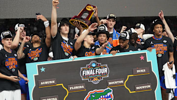 Apr 7, 2025; San Antonio, TX, USA;  Florida Gators players celebrate with the trophy after defeating the Houston Cougars in the national championship game of the Final Four of the 2025 NCAA Tournament at the Alamodome. Mandatory Credit: Robert Deutsch-Imagn Images