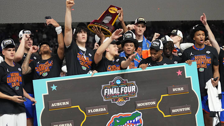 Apr 7, 2025; San Antonio, TX, USA;  Florida Gators players celebrate with the trophy after defeating the Houston Cougars in the national championship game of the Final Four of the 2025 NCAA Tournament at the Alamodome. Mandatory Credit: Robert Deutsch-Imagn Images