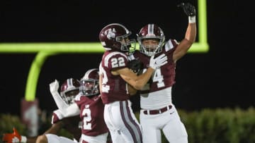 First Baptist Academy Lions corner back Logan Bartley (24) and running back Sam Sparacio (22) celebrate after a turnover during the first quarter of the Class 1S state semifinal against the Munroe Bobcats at First Baptist Academy in Naples on Friday, Dec. 2, 2022.