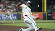 Mar 31, 2025; Houston, Texas, USA;  Houston Astros third baseman Isaac Paredes (15) slides safely into third base against the San Francisco Giants in the first inning at Daikin Park.