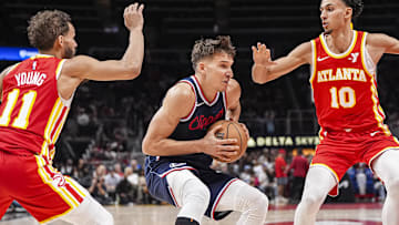 Mar 14, 2025; Atlanta, Georgia, USA; LA Clippers guard Bogdan Bogdanovic (10) handles the ball between Atlanta Hawks guard Trae Young (11) and forward Zaccharie Risacher (10) during the second half at State Farm Arena. Mandatory Credit: Dale Zanine-Imagn Images