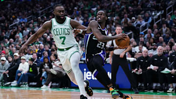 Jan 10, 2025; Boston, Massachusetts, USA; Sacramento Kings guard Keon Ellis (23) drives the ball against Boston Celtics guard Jaylen Brown (7) in the second quarter at TD Garden. Mandatory Credit: David Butler II-Imagn Images