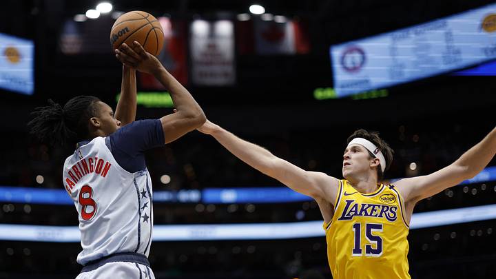 Jan 30, 2025; Washington, District of Columbia, USA; Washington Wizards guard Bub Carrington (8) shoots the ball over Los Angeles Lakers guard Austin Reaves (15) in the third quarter at Capital One Arena. Mandatory Credit: Geoff Burke-Imagn Images