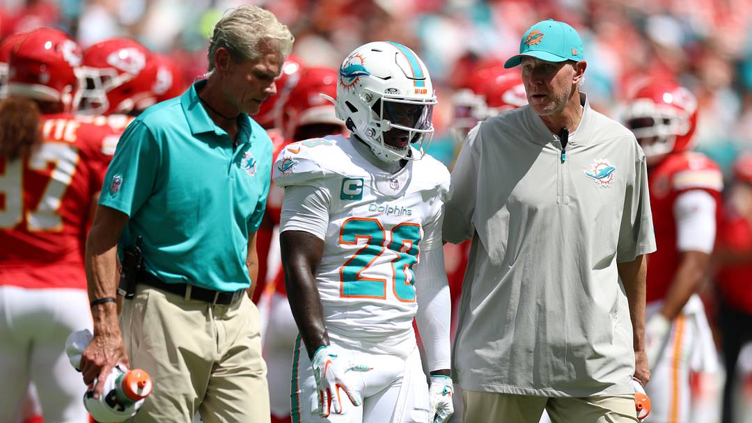 Miami Dolphins running back De'Von Achane (28) is walked off the field during the first quarter against the Kansas City Chiefs at Hard Rock Stadium.
