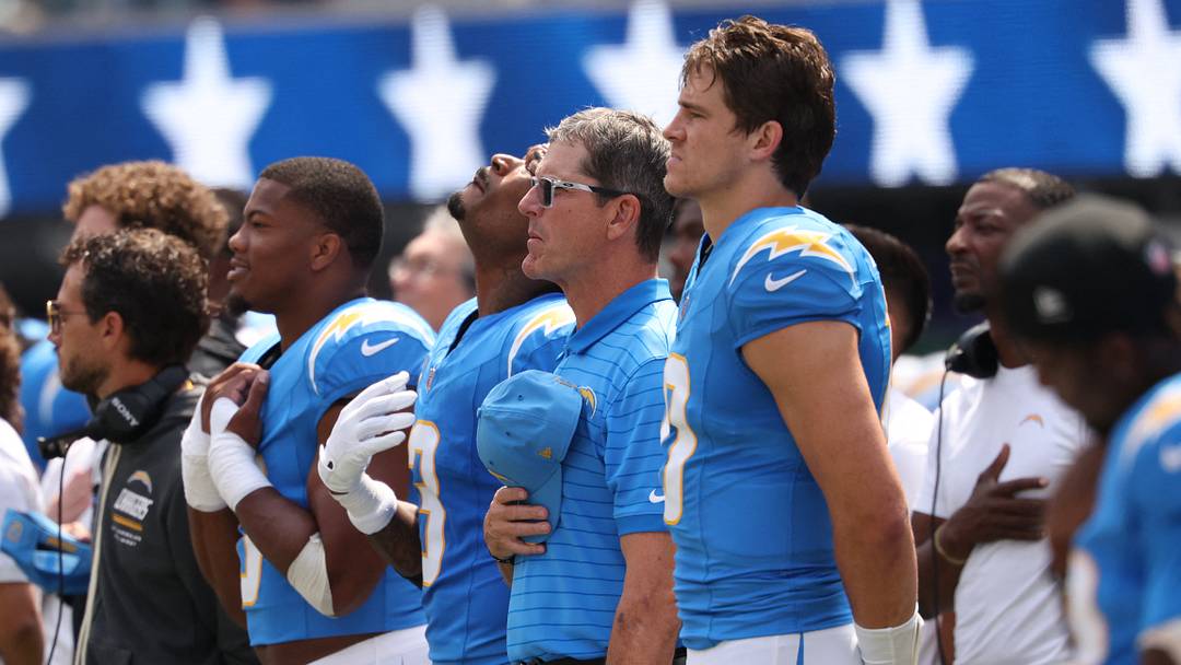 Sep 13, 2026; Inglewood, California, USA;  Los Angeles Chargers head coach Jim Harbaugh and quarterback Justin Herbert (10) stands during the national anthem prior to a game against the Arizona Cardinals at SoFi Stadium.  Mandatory Credit: Kiyoshi Mio-Imagn Images